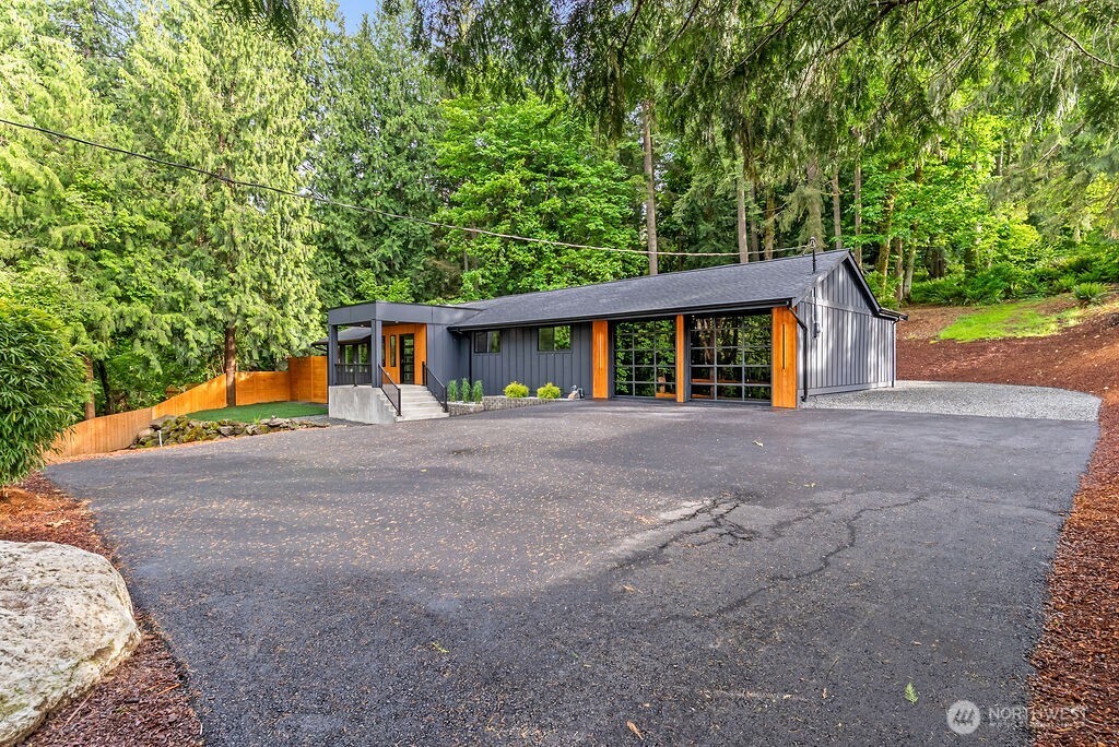 19433 Southeast 128th Street Renton, WA 98059 - Photo 4 of 40 a front view of house with yard and trees in the background