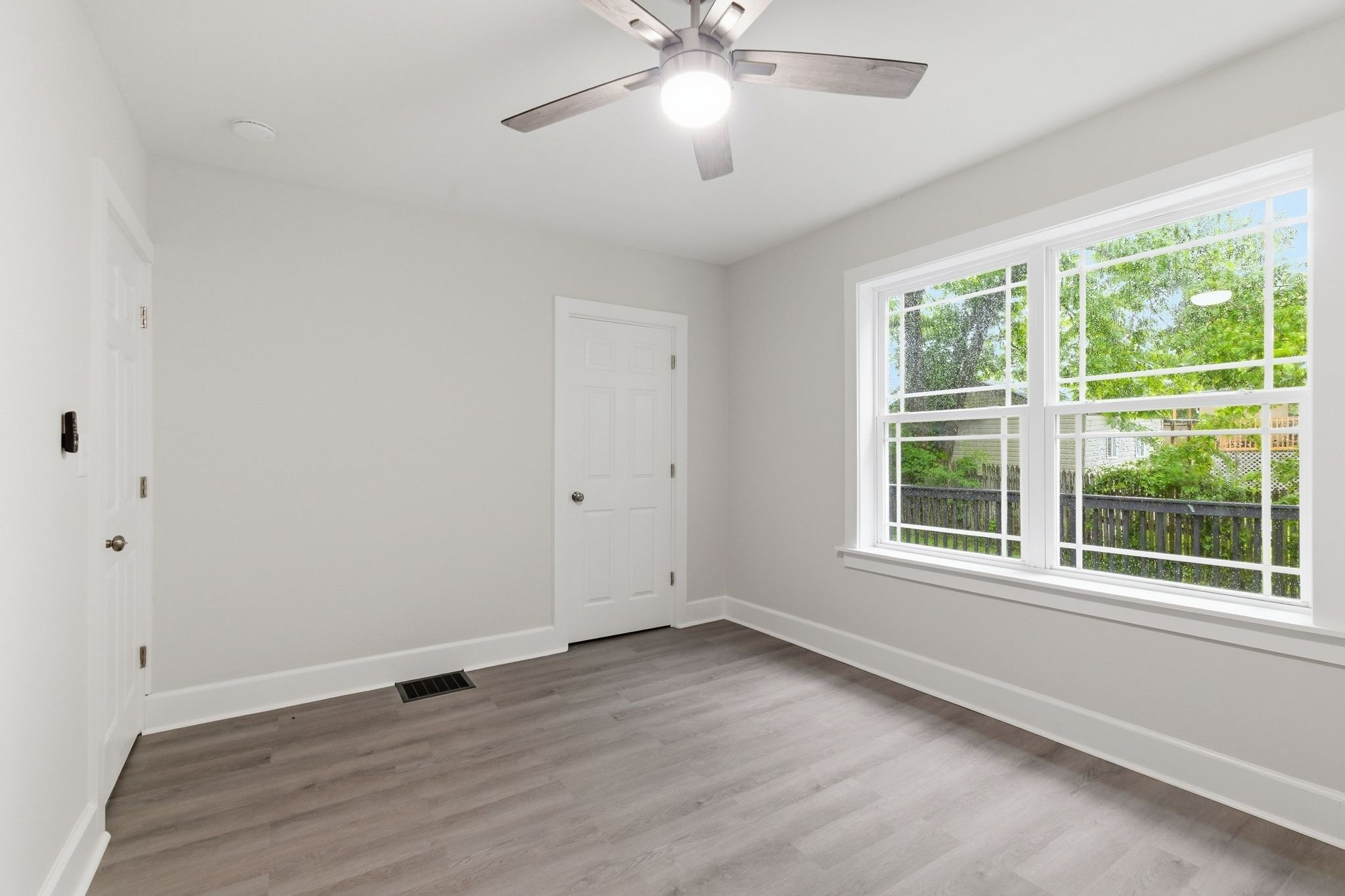 305 South Irwin Street Manchester, TN 37355 - Photo 20 of 40 a view of an empty room with wooden floor and a window