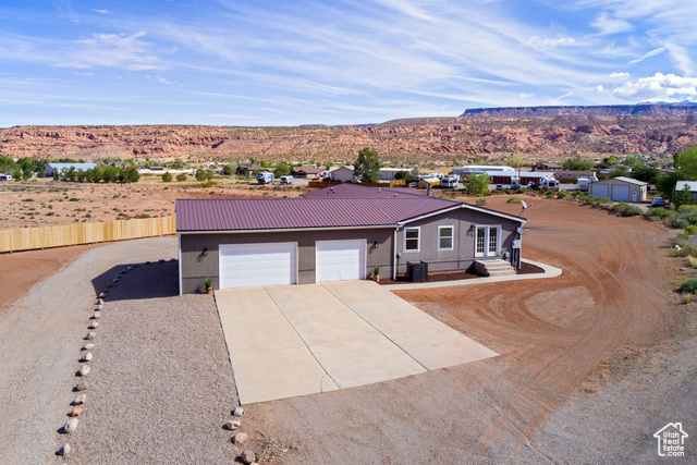 33 Merriam Court Moab, UT 84532 - Photo 2 of 56 View of garage and driveway to downstairs entrance. Amazing view of red rocks.