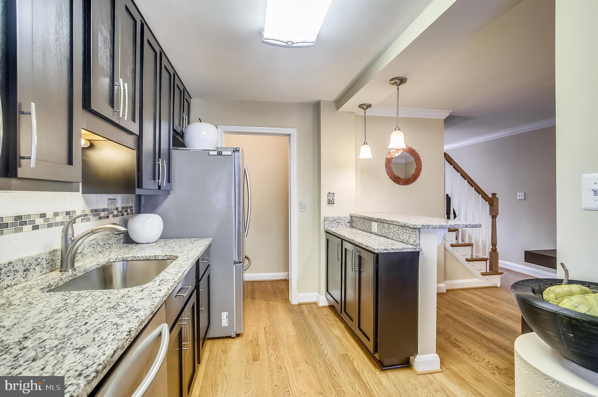 1409 Langford Road Baltimore, MD 21207 - Photo 10 of 39 a kitchen with a sink stove and refrigerator