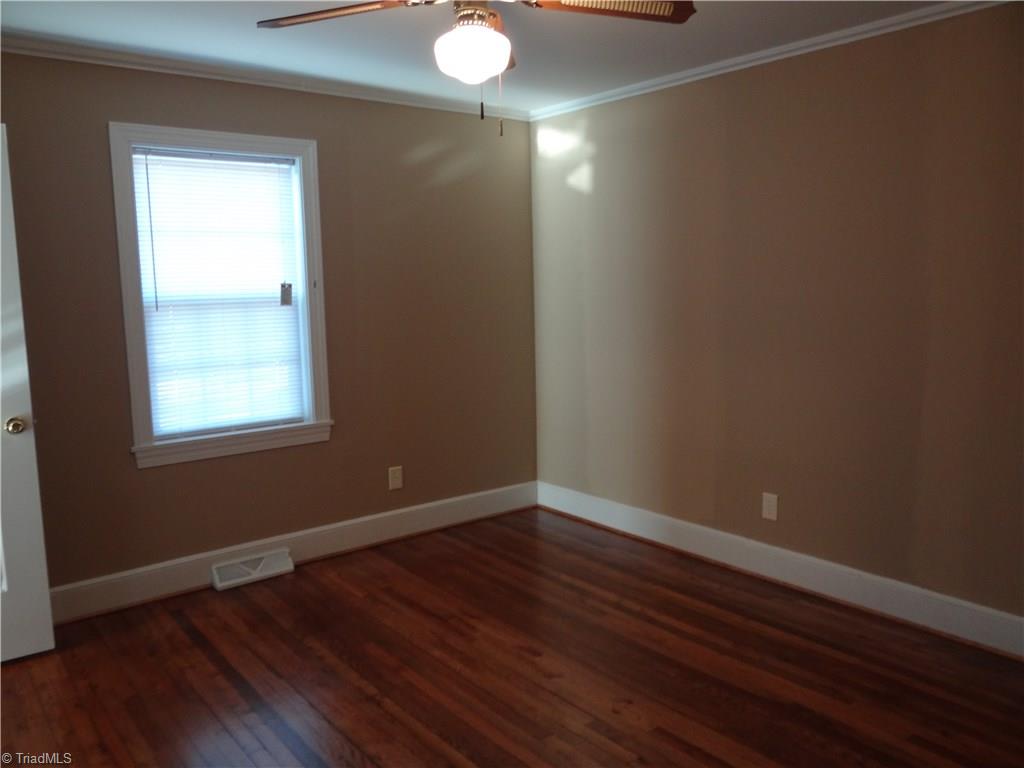 524 High Point Street Randleman, NC 27317 - Photo 13 of 30 Master bedroom with hardwood flooring, walk in closet and on the main level