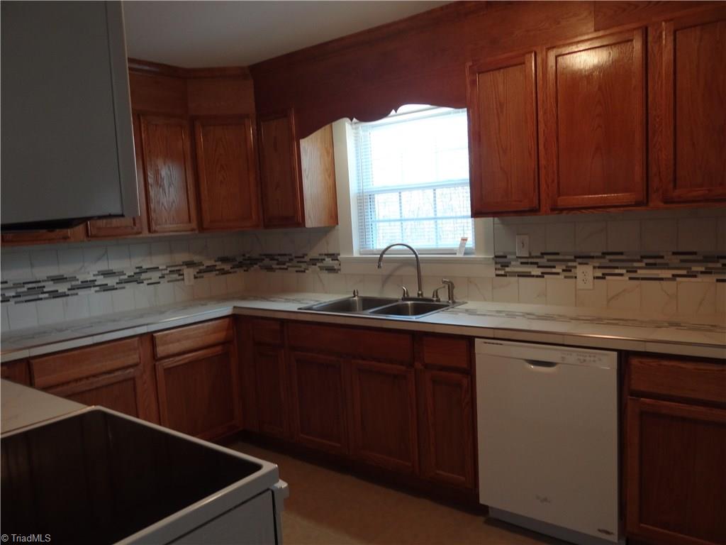 524 High Point Street Randleman, NC 27317 - Photo 5 of 30 Kitchen with new cabinets, tile countertops and tile splash