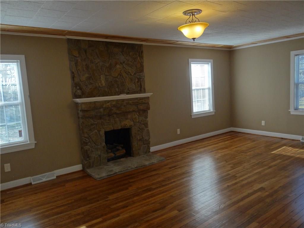 524 High Point Street Randleman, NC 27317 - Photo 9 of 30 Living room with gas log stone fireplace