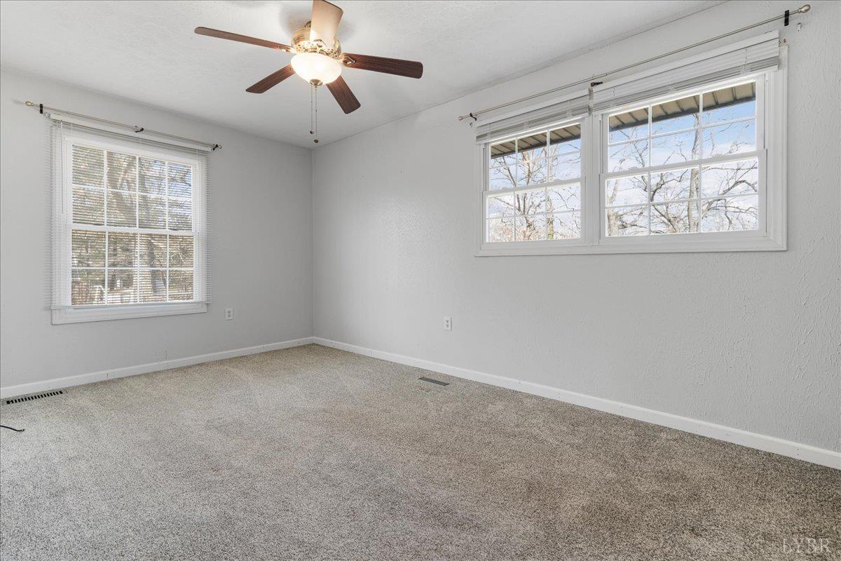 813 Doss Road Concord, VA 24538 - Photo 11 of 31 an empty room with a window and a fan