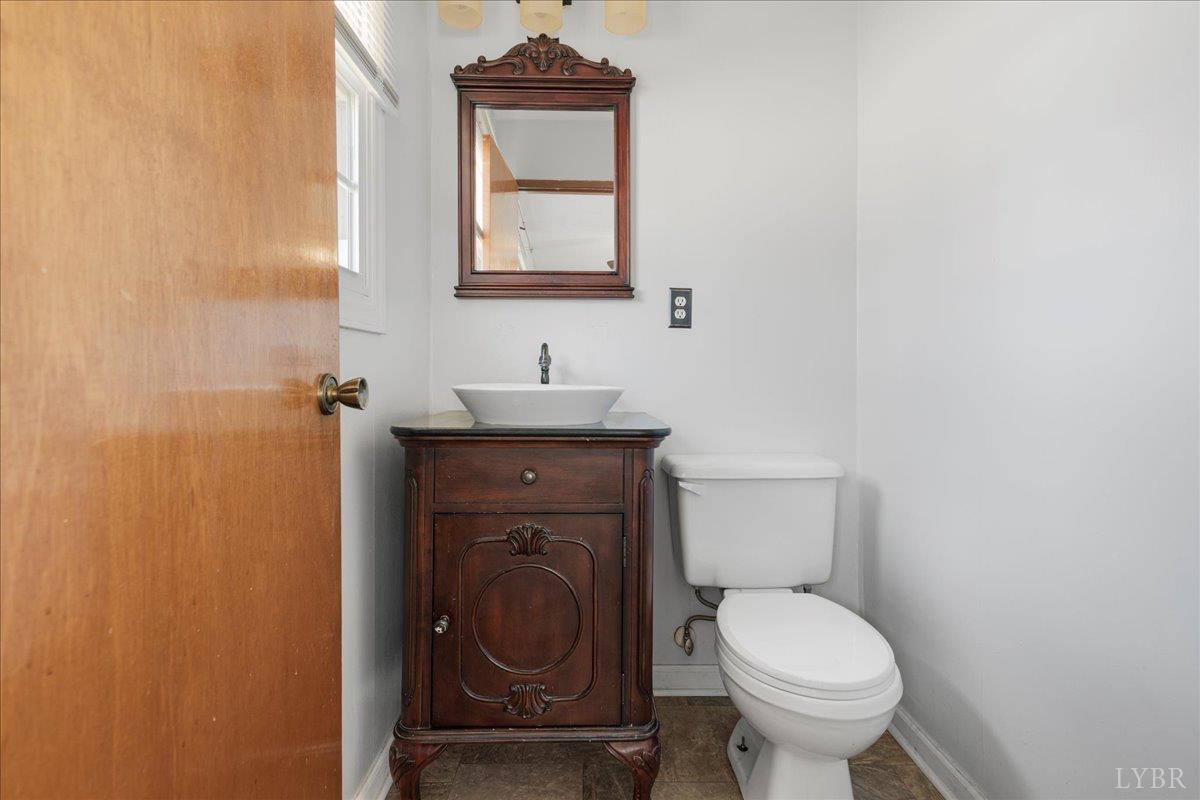 813 Doss Road Concord, VA 24538 - Photo 14 of 31 a bathroom with a toilet sink and mirror