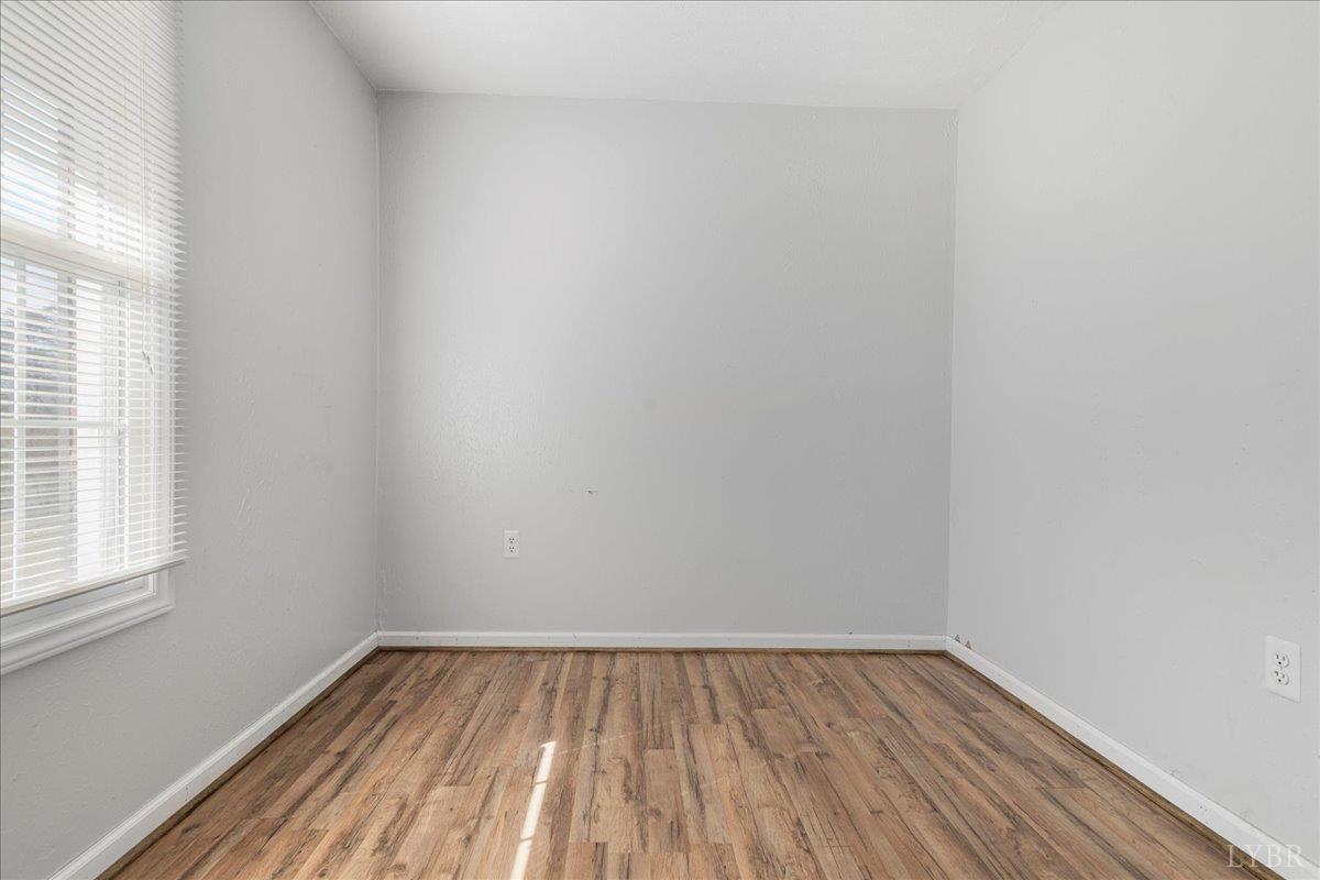 813 Doss Road Concord, VA 24538 - Photo 9 of 31 a view of an empty room with wooden floor and a window