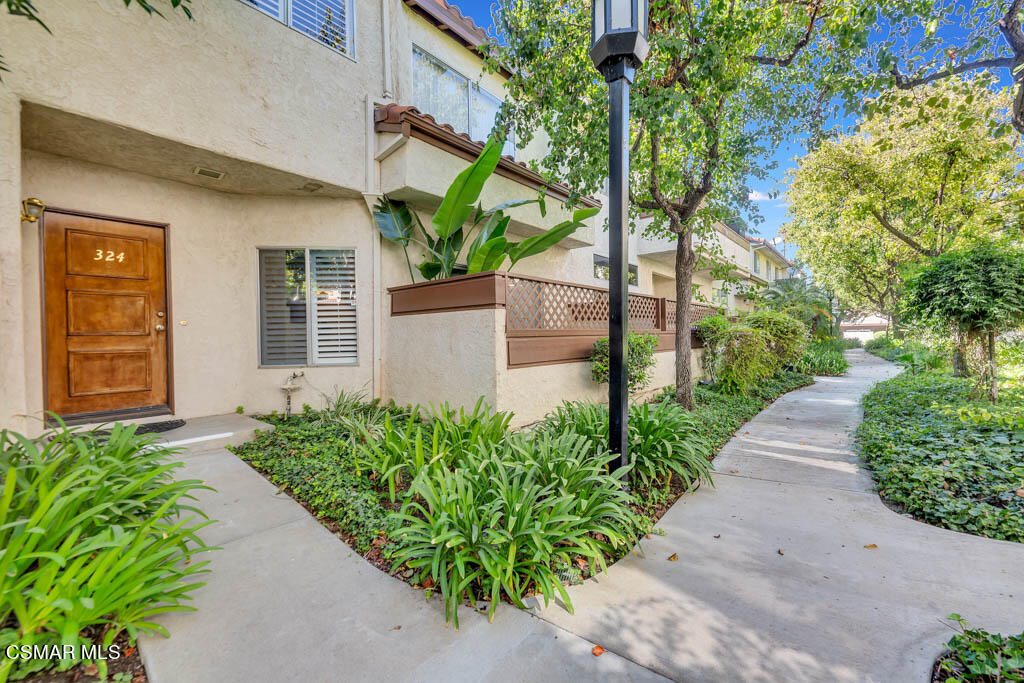 1736 Sinaloa Road, Unit 324 Simi Valley, CA 93065 - Photo 1 of 37 a couple of flower plants in front of yellow house