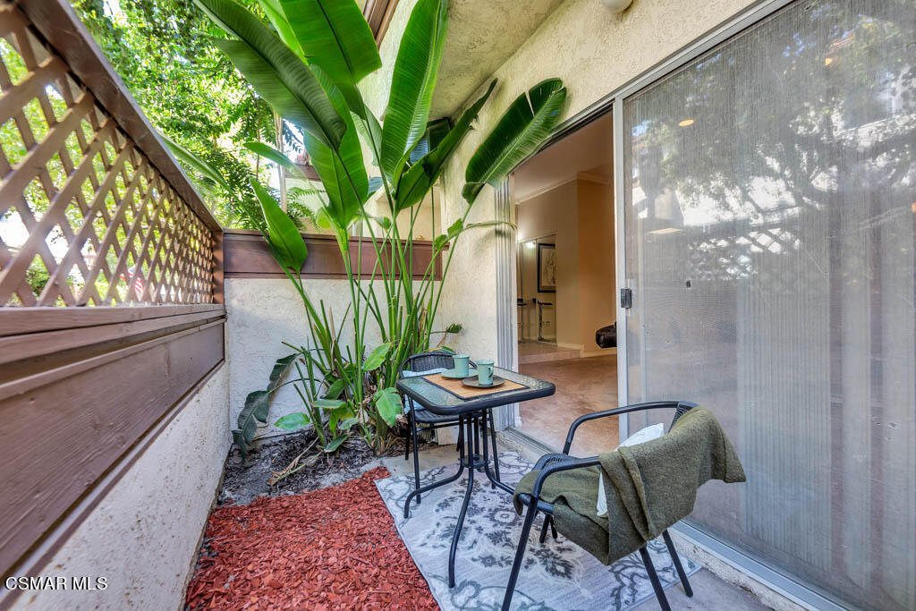 1736 Sinaloa Road, Unit 324 Simi Valley, CA 93065 - Photo 19 of 37 a view of a chairs and table in patio with wooden fence
