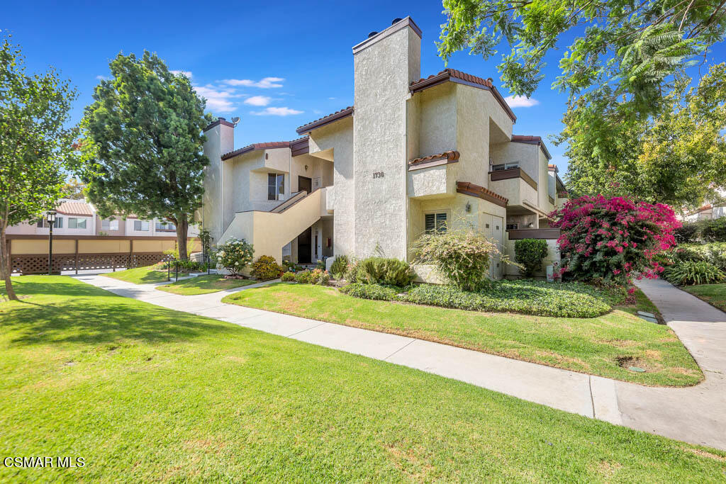 1736 Sinaloa Road, Unit 324 Simi Valley, CA 93065 - Photo 21 of 37 a front view of a house with a yard and fountain