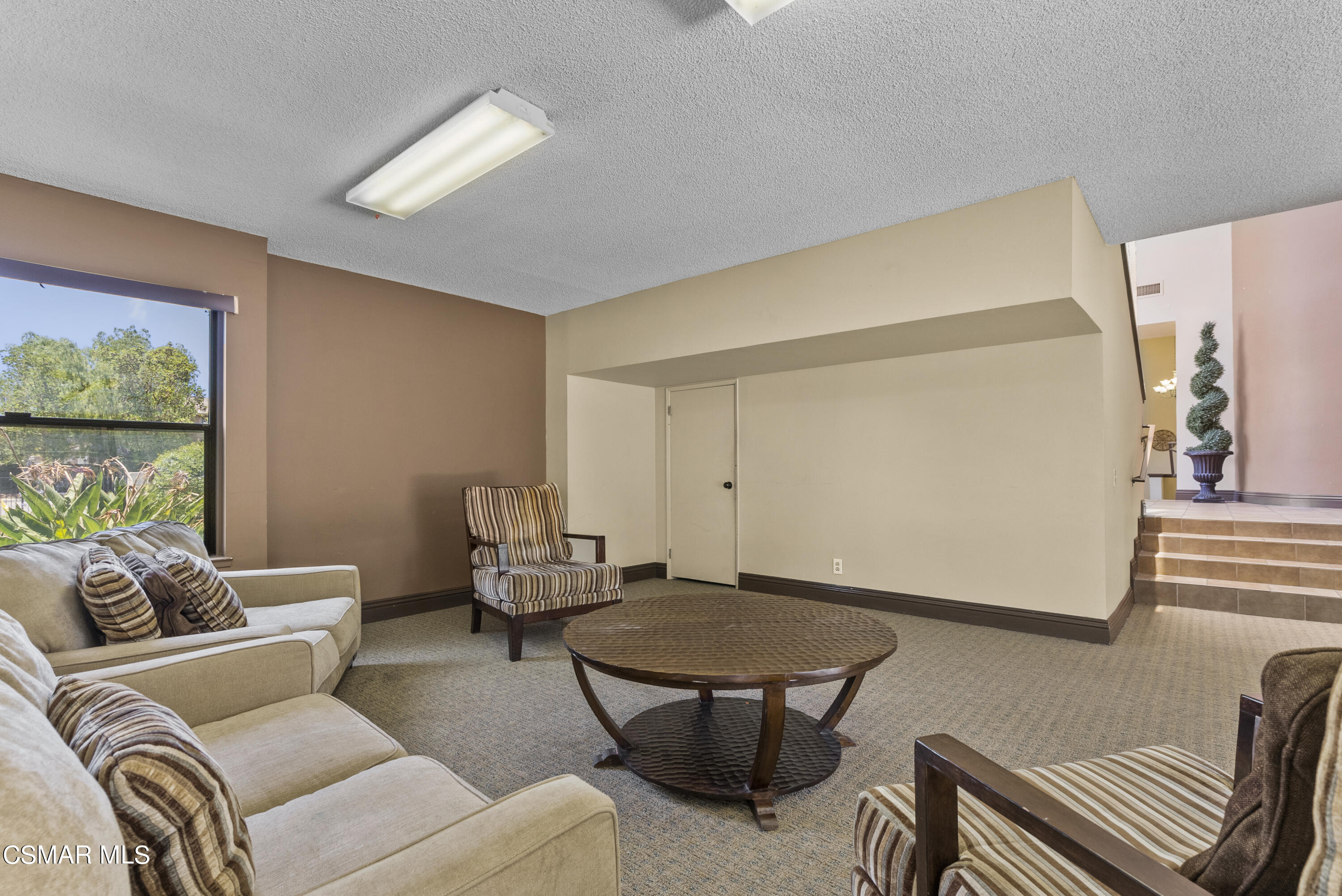 1736 Sinaloa Road, Unit 324 Simi Valley, CA 93065 - Photo 29 of 37 a living room with furniture a rug and a window