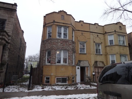 a view of a brick house with many windows