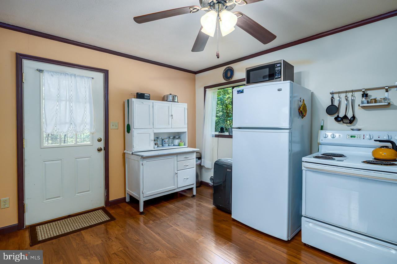 1017 North Maple Road Mount Jackson, VA 22842 - Photo 6 of 37 a kitchen with a refrigerator a stove cabinets and wooden floor