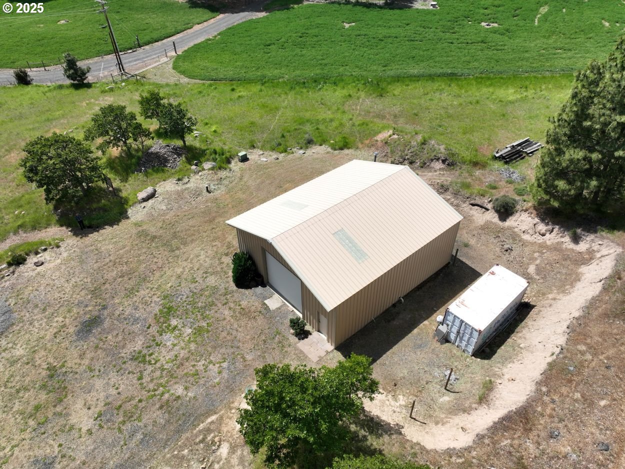4397 Browns Creek Road The Dalles, OR 97058 - Photo 22 of 37 a view of a backyard with lawn chairs under an umbrella