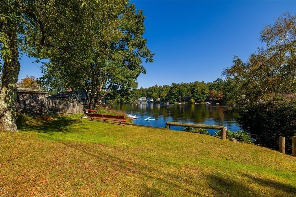 117 May Brook Road Holland, MA 01521 - Photo 21 of 30 a view of a swimming pool with a bench and trees