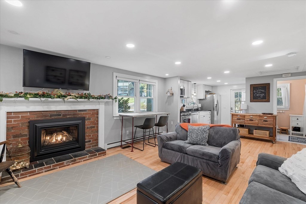 117 May Brook Road Holland, MA 01521 - Photo 4 of 30 a living room with furniture a flat screen tv and a fireplace