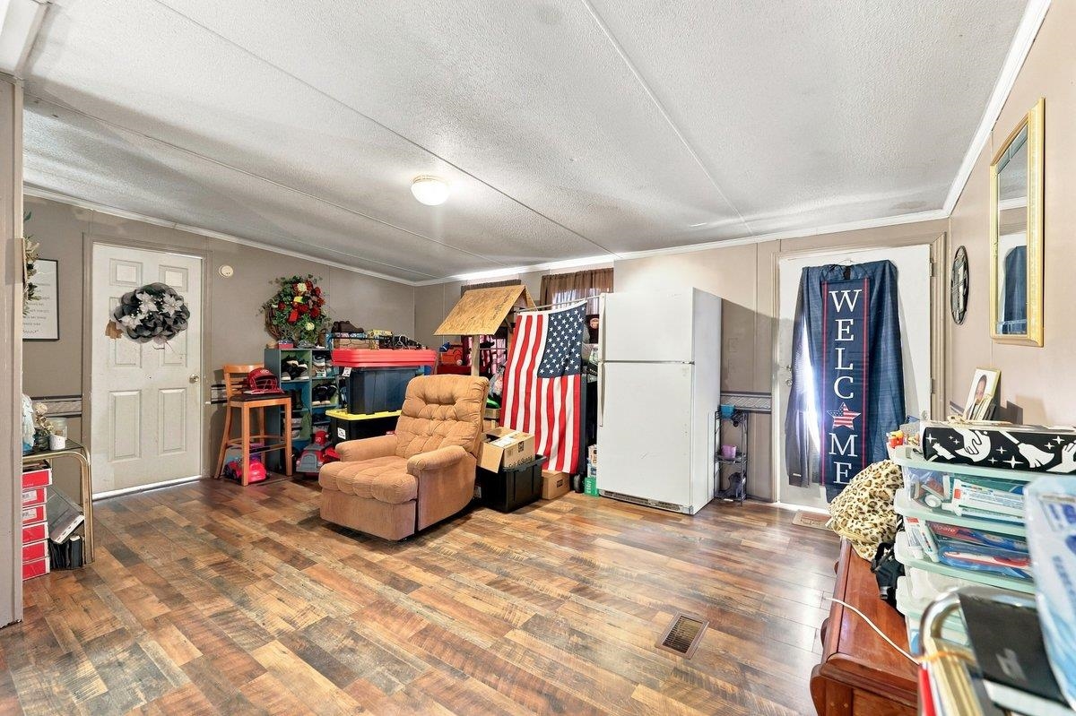 3416 Dulaney Road Mosheim, TN 37818 - Photo 13 of 27 Spacious interior featuring wood-finish flooring, light-toned walls, and white trim