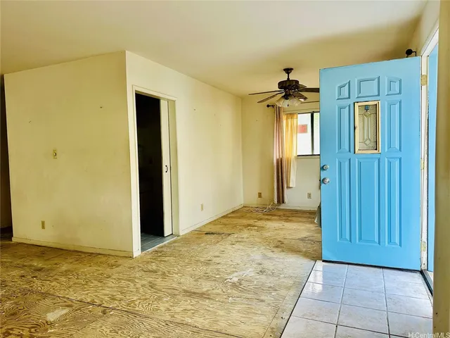 a view of empty room with a window and wooden floor