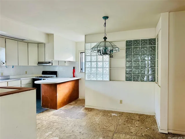 a kitchen with stainless steel appliances granite countertop a refrigerator sink and stove