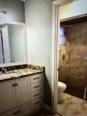 a kitchen with granite countertop stainless steel appliances and wooden cabinets