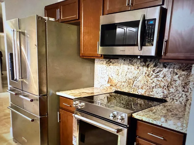 a kitchen with sink cabinets and appliances