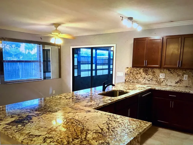 a kitchen with a sink and large cabinets