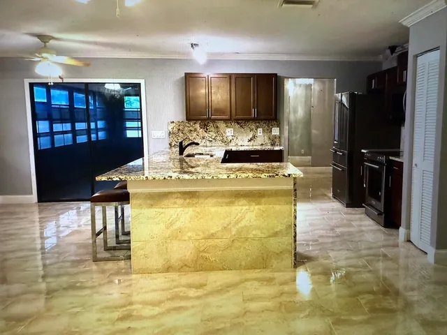 a view of a kitchen with cabinets and stainless steel appliances