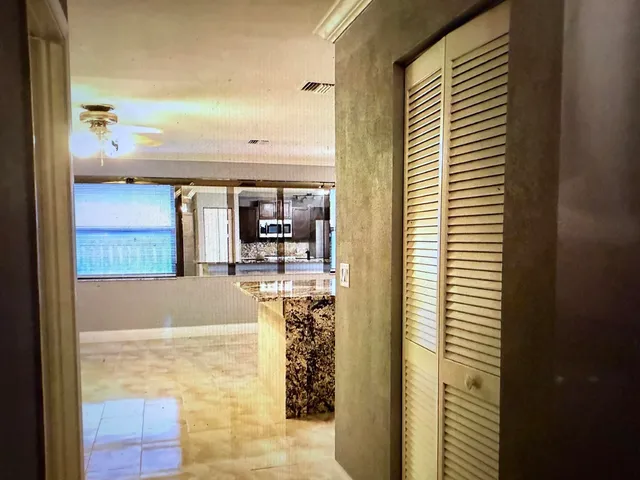 a view of a hallway with a chandelier and entryway