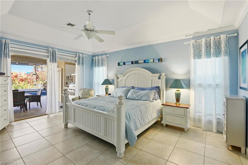 11180 Phoenix Way Naples, FL 34119 - Photo 15 of 43 Bedroom featuring multiple windows, ceiling fan, a raised ceiling, and light tile patterned flooring