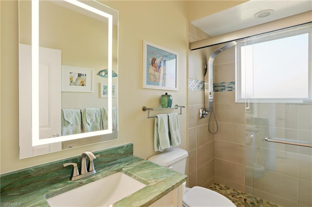 11180 Phoenix Way Naples, FL 34119 - Photo 21 of 43 Full bathroom featuring vanity and a stall shower