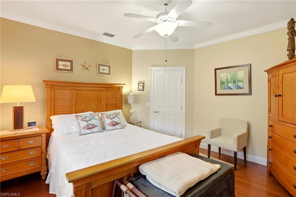 11180 Phoenix Way Naples, FL 34119 - Photo 22 of 43 Bedroom with crown molding, dark wood-style flooring, and a ceiling fan
