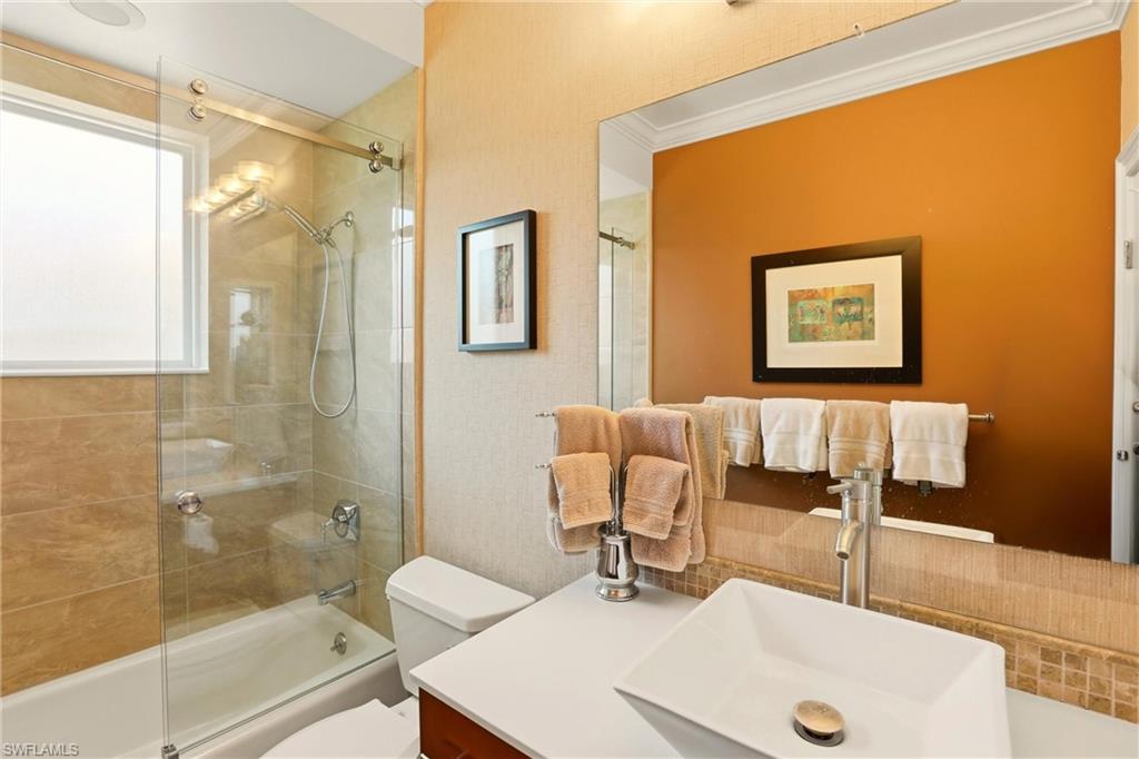 11180 Phoenix Way Naples, FL 34119 - Photo 23 of 43 Bathroom featuring vanity, enclosed tub / shower combo, and ornamental molding
