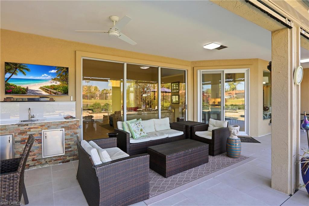 11180 Phoenix Way Naples, FL 34119 - Photo 24 of 43 View of patio featuring a ceiling fan and an outdoor kitchen with living area