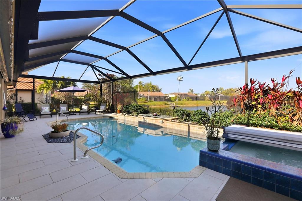 11180 Phoenix Way Naples, FL 34119 - Photo 32 of 43 Swimming pool featuring a sunroom, a patio area, a lanai, a residential view, and a hot tub