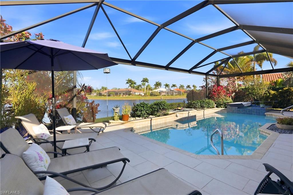 11180 Phoenix Way Naples, FL 34119 - Photo 33 of 43 Swimming pool featuring a lanai, a patio area, a sunroom, and a water view