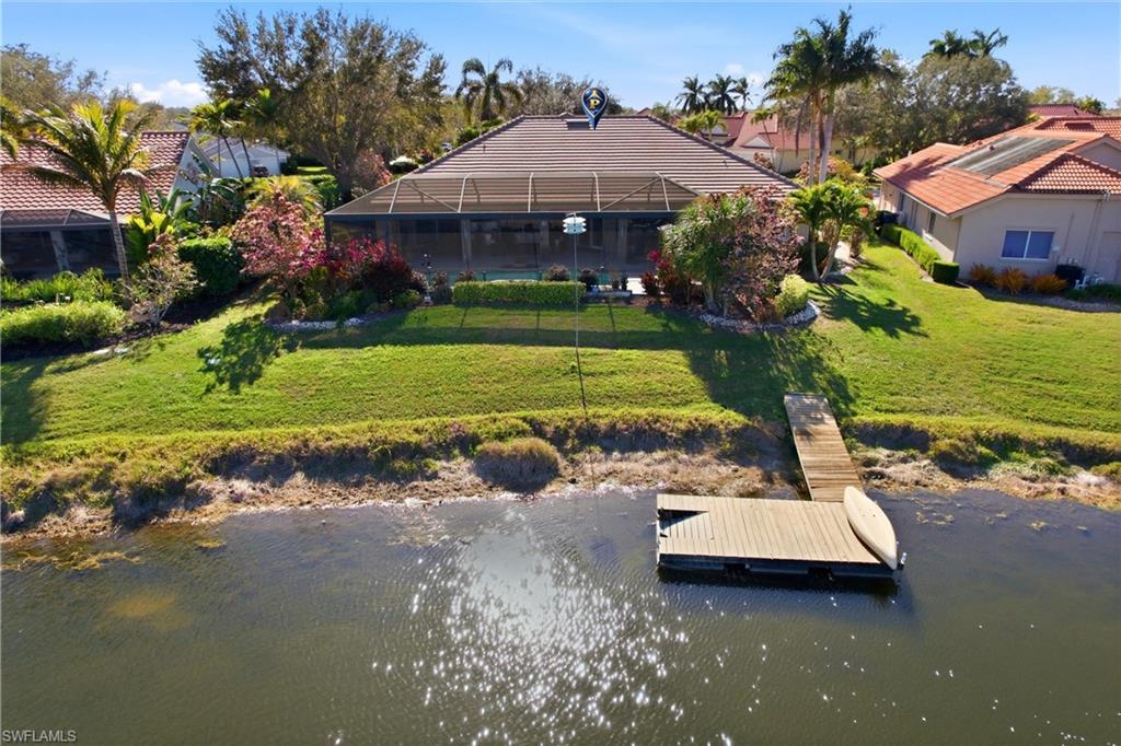 11180 Phoenix Way Naples, FL 34119 - Photo 35 of 43 Dock area featuring a water view, a yard, a lanai, and a sunroom