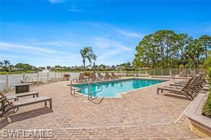 11180 Phoenix Way Naples, FL 34119 - Photo 42 of 43 Community pool featuring a patio area