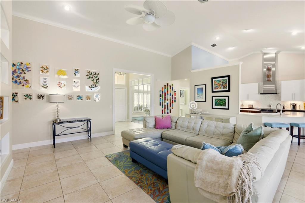 11180 Phoenix Way Naples, FL 34119 - Photo 6 of 43 Living area featuring ceiling fan, ornamental molding, light tile patterned floors, and lofted ceiling