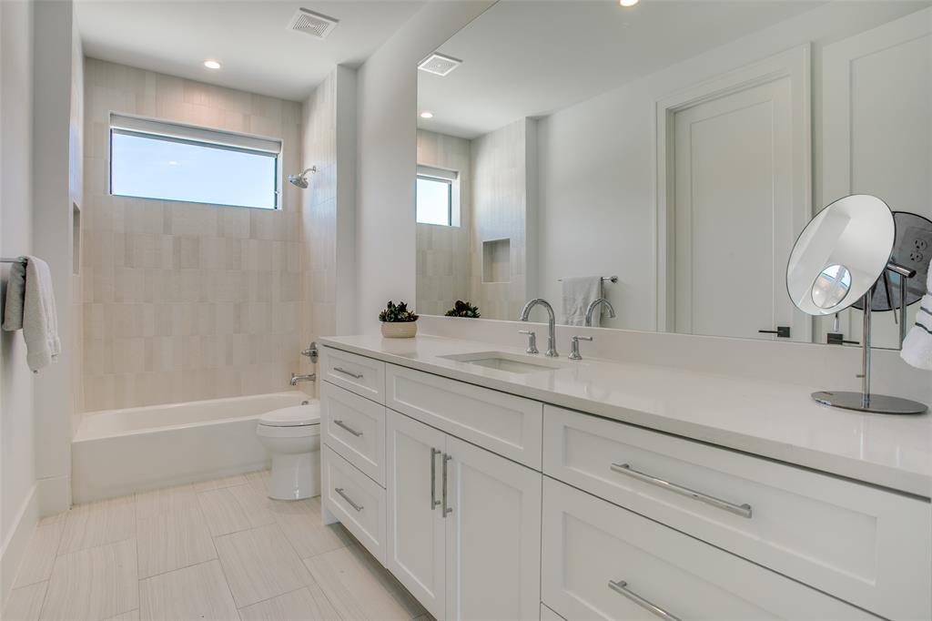 9721 Kerrisdale Lane Dallas, TX 75230 - Photo 15 of 25 a bathroom with a sink a toilet and a bathtub