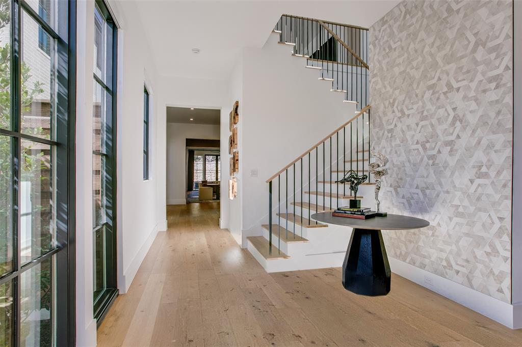 9721 Kerrisdale Lane Dallas, TX 75230 - Photo 21 of 25 a view of a hallway with wooden floor and staircase