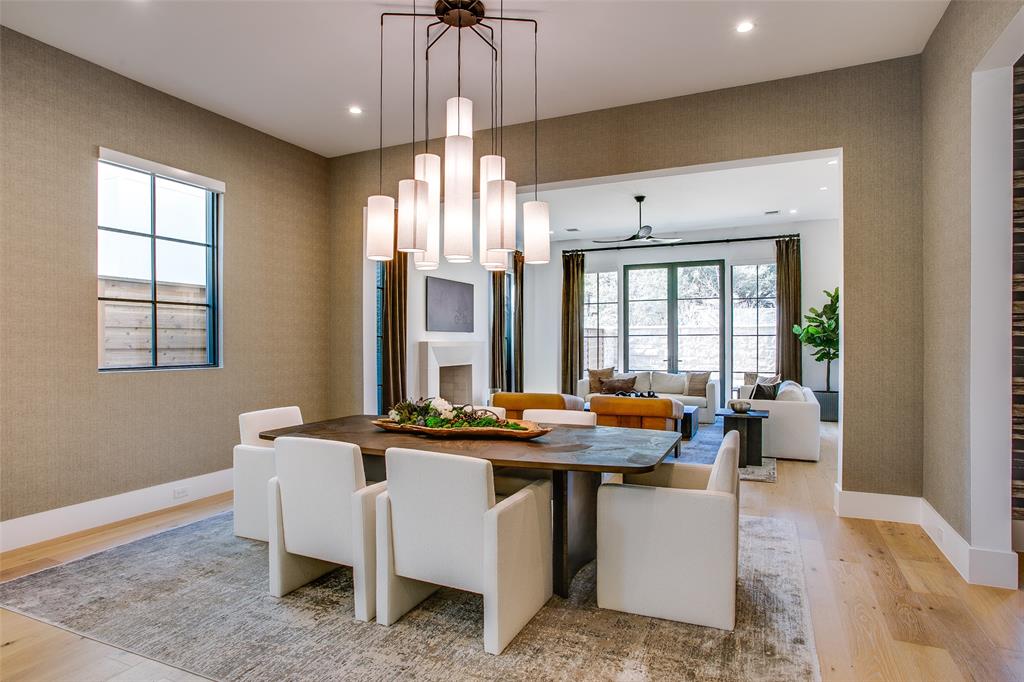 9721 Kerrisdale Lane Dallas, TX 75230 - Photo 2 of 25 a dining hall with couches a dining table and chairs with wooden floor