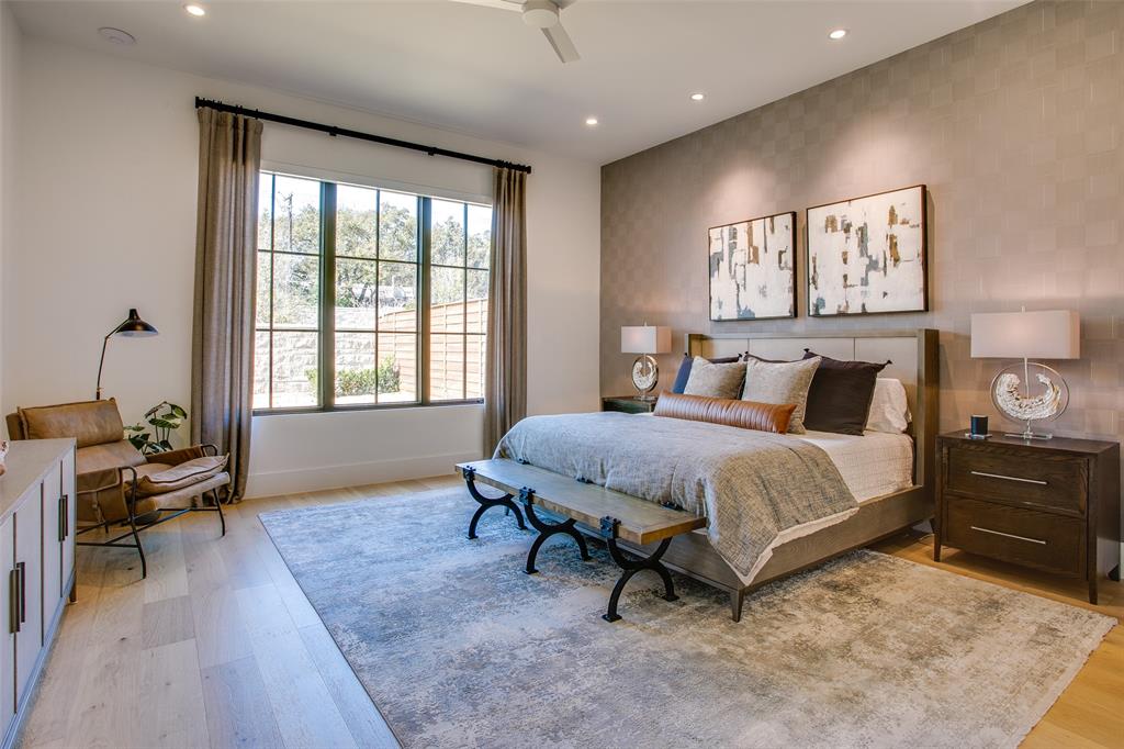 9721 Kerrisdale Lane Dallas, TX 75230 - Photo 6 of 25 a bedroom with a bed and wooden floor