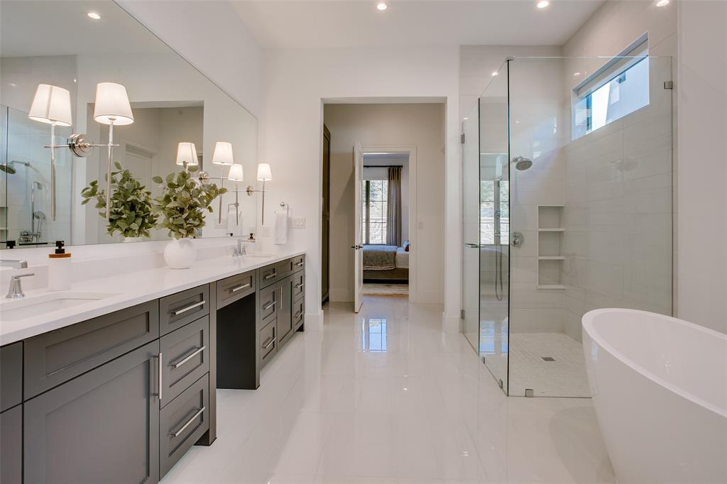 9721 Kerrisdale Lane Dallas, TX 75230 - Photo 7 of 25 a spacious bathroom with a double vanity sink a toilet a mirror and shower