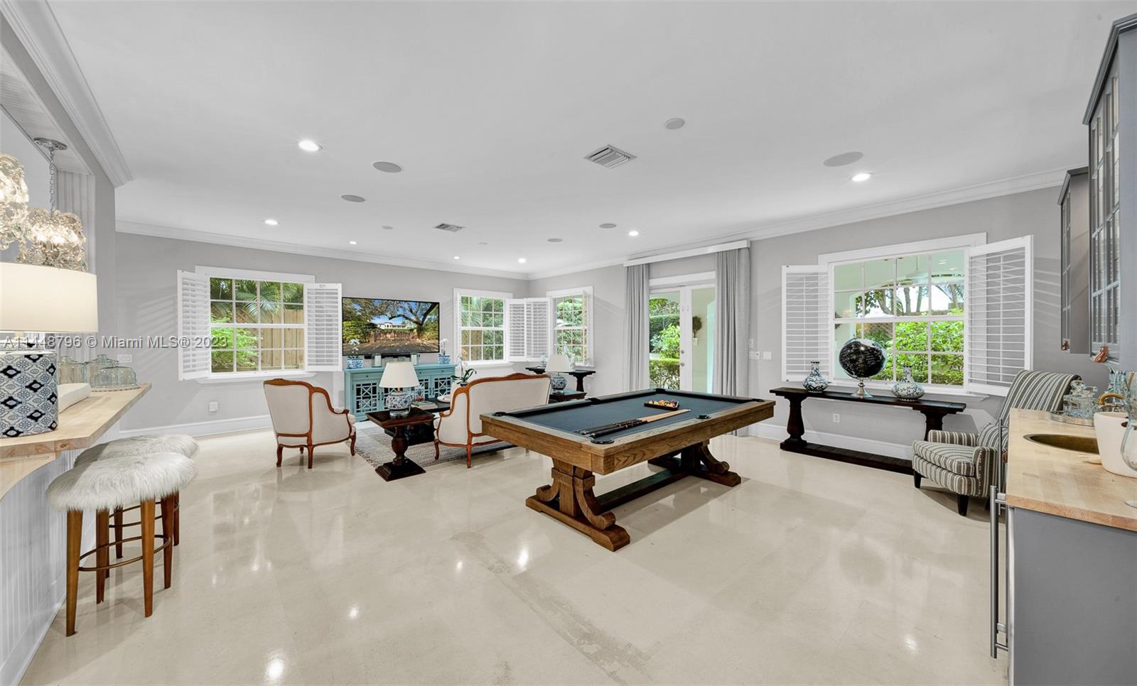 4270 Lennox Drive Miami, FL 33133 - Photo 10 of 39 a living room with furniture gym equipment and large windows