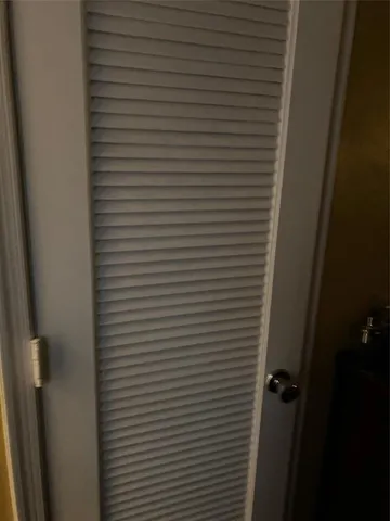 a bed sitting in a bedroom next to a lamp