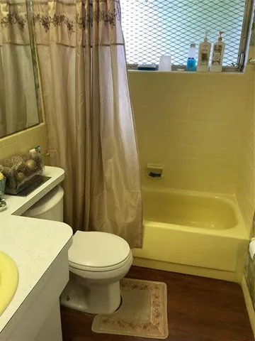 a bathroom with a toilet and shower
