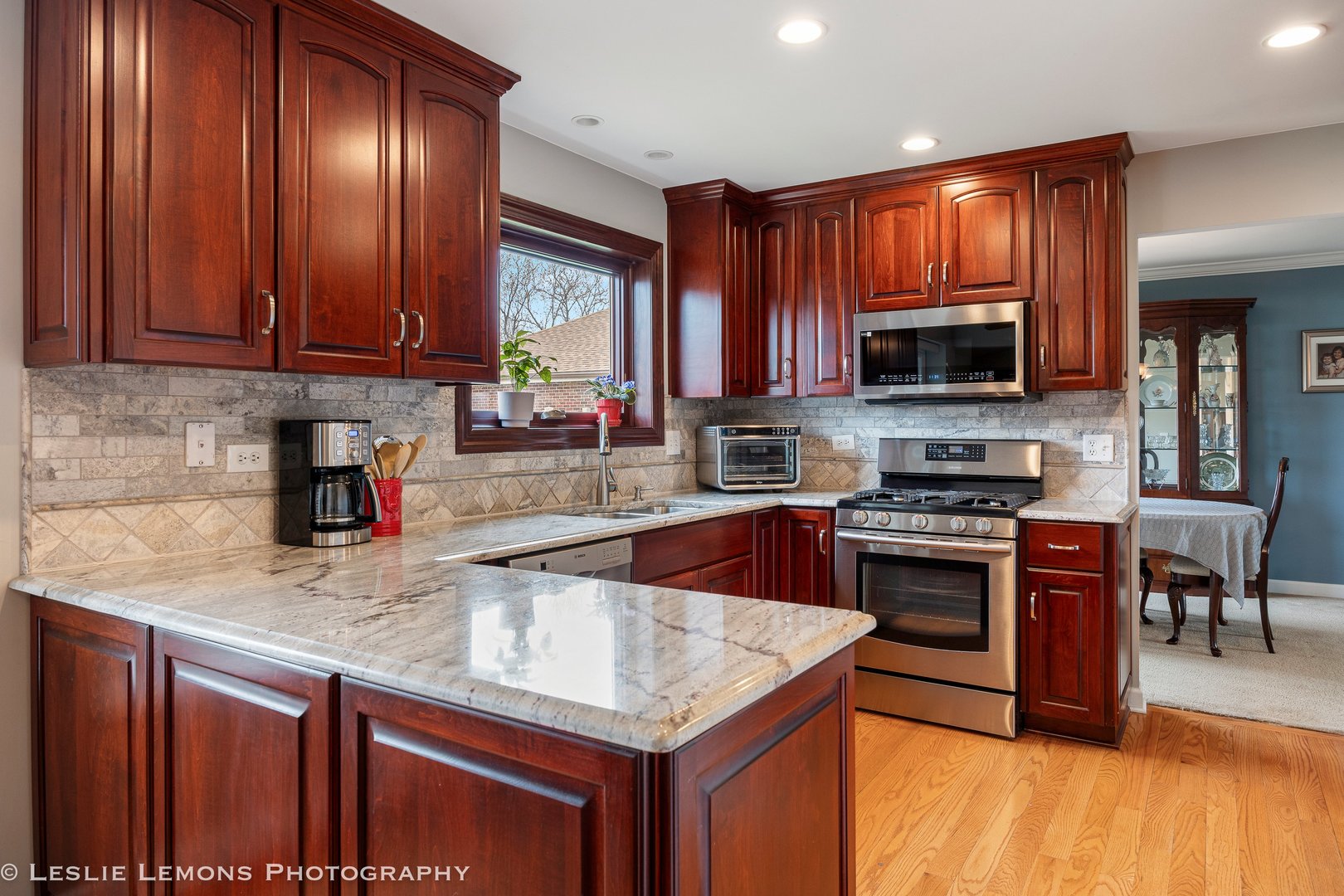 3432 Drover Lane Darien, IL 60561 - Photo 2 of 29 a kitchen with stainless steel appliances granite countertop a stove a sink dishwasher and a microwave oven with wooden cabinets
