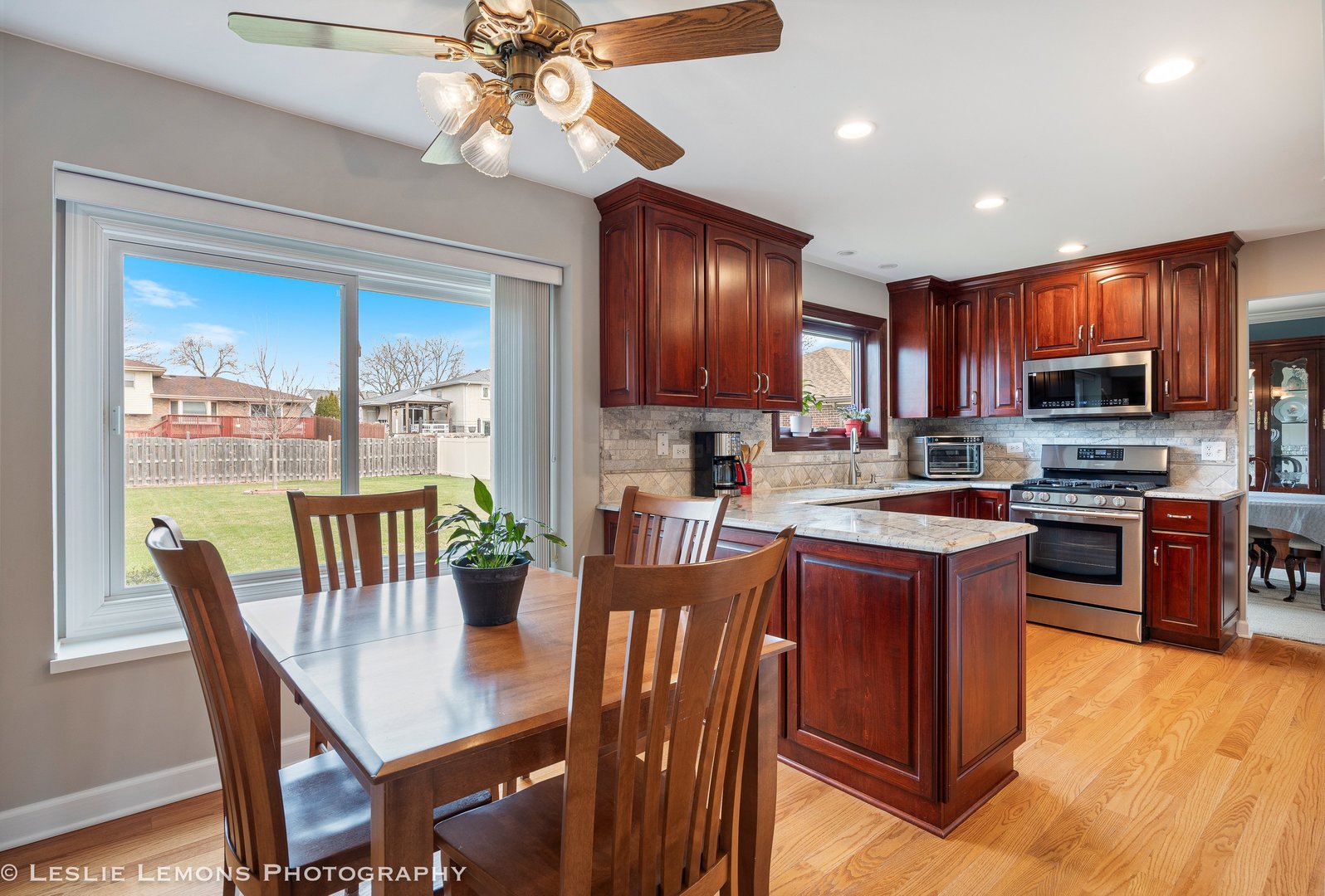 3432 Drover Lane Darien, IL 60561 - Photo 6 of 29 a kitchen with stainless steel appliances granite countertop a stove a refrigerator a kitchen island a dining table and chairs