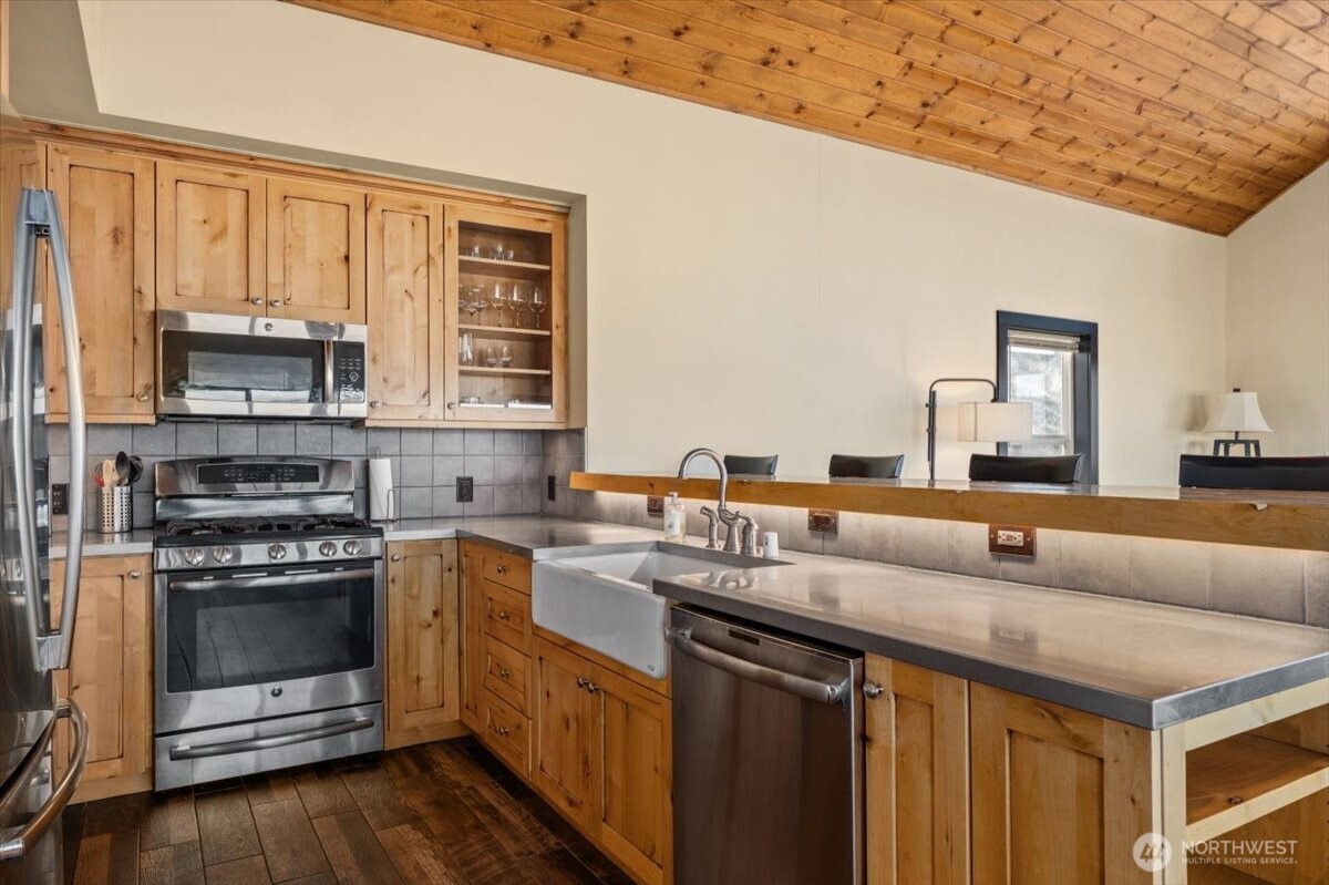 420 Plata Road Brewster, WA 98812 - Photo 12 of 36 a kitchen with stainless steel appliances granite countertop a stove a sink and a microwave