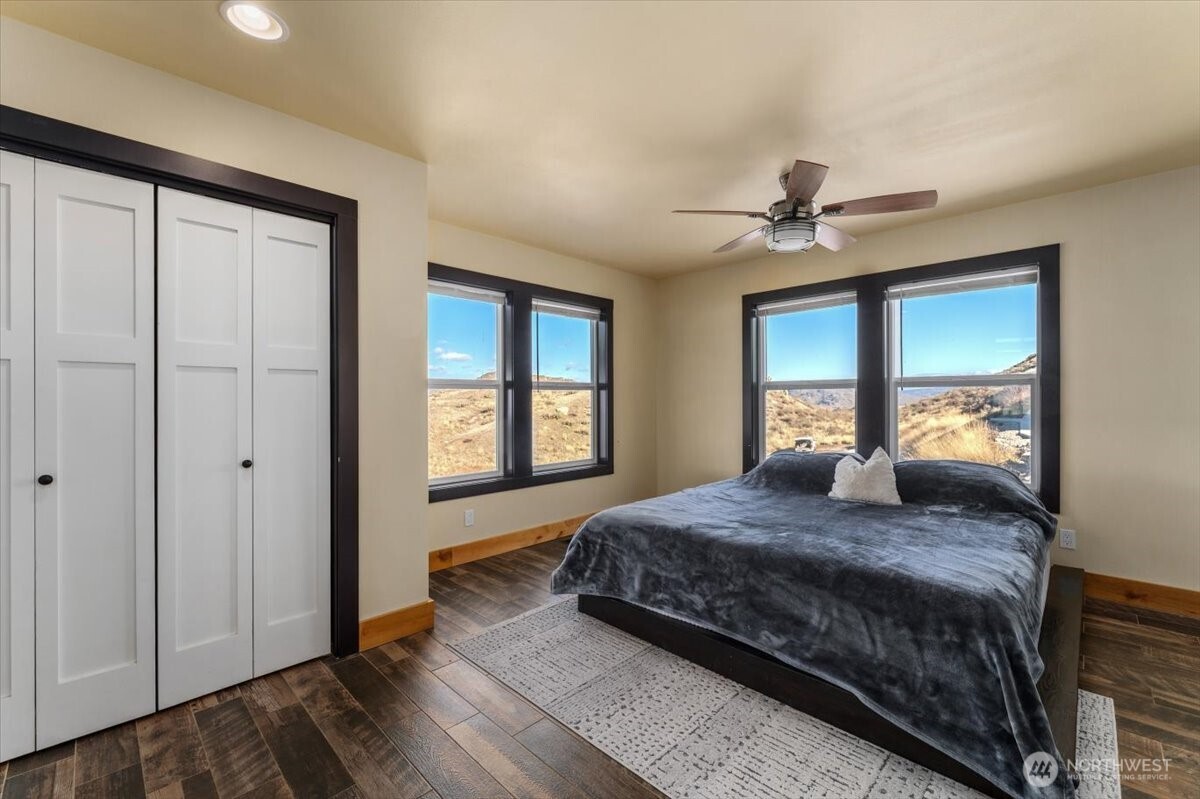 420 Plata Road Brewster, WA 98812 - Photo 14 of 36 a bedroom with a large bed closet and window