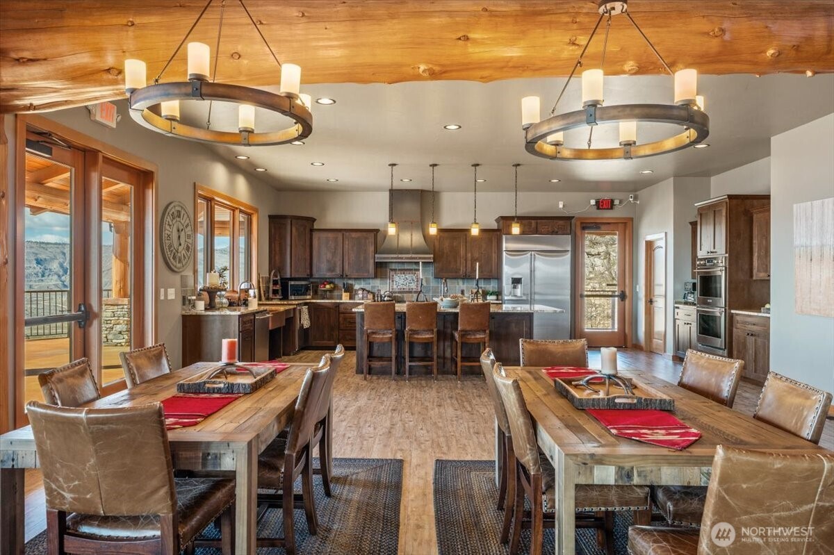 420 Plata Road Brewster, WA 98812 - Photo 35 of 36 a dining room with furniture a chandelier and a rug